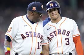 Astros coach talking to baseball player